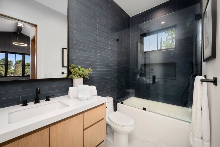 Modern bathroom interior with sleek design featuring glass shower and white vanity