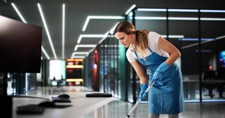 Professional cleaner mopping floor in commercial setting