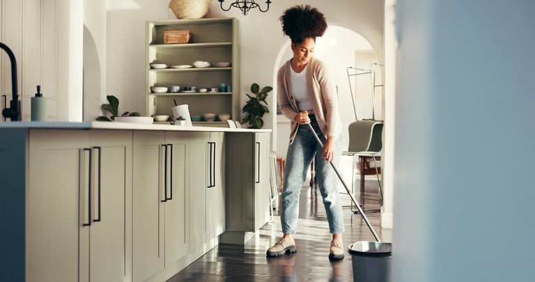 Professional cleaner doing detailed cleaning in bright kitchen