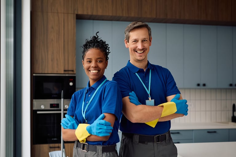 Happy diverse professional cleaners standing together